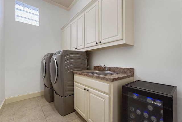 clothes washing area with washer and dryer, light tile patterned flooring, cabinets, ornamental molding, and sink