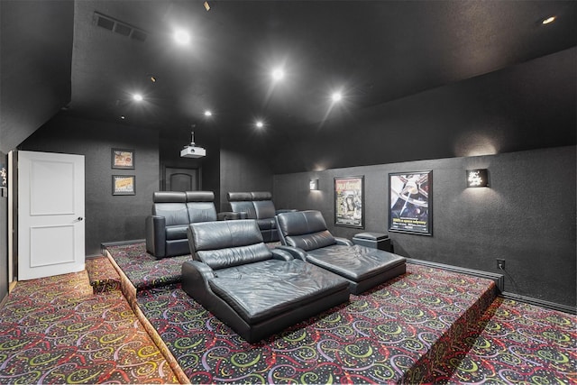 carpeted home theater featuring lofted ceiling