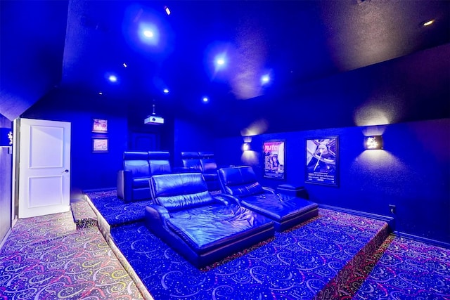 cinema featuring vaulted ceiling and carpet flooring