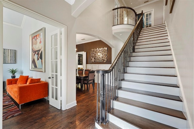 stairway featuring hardwood / wood-style flooring and crown molding