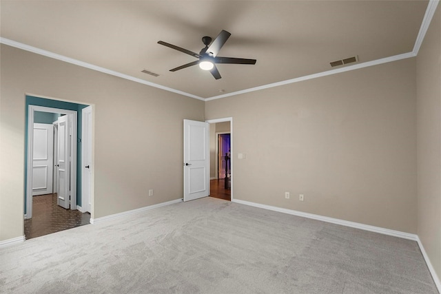 unfurnished bedroom featuring ceiling fan, carpet, and crown molding