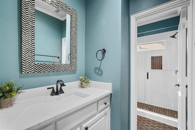 bathroom with walk in shower and vanity