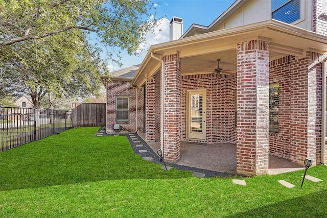 view of home's exterior featuring ceiling fan and a yard