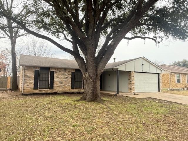 ranch-style house featuring a garage and a front yard