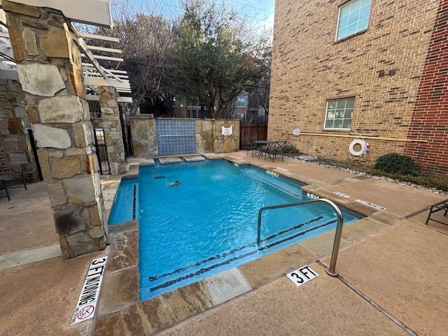 view of swimming pool with a patio area