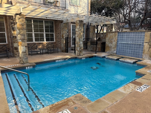 view of swimming pool with a pergola