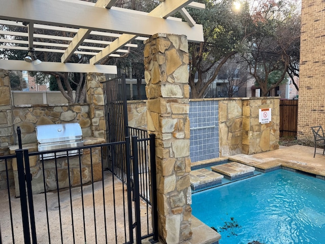 view of pool featuring exterior kitchen, area for grilling, and a pergola