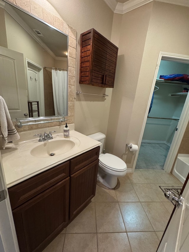 bathroom with toilet, vanity, tile patterned flooring, and ornamental molding