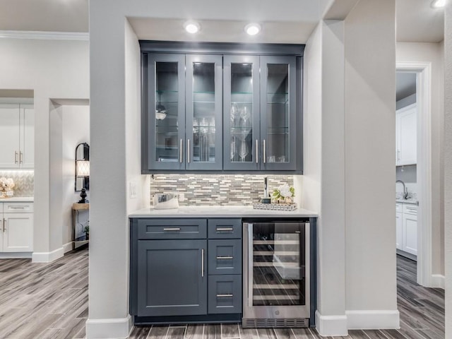 bar with hardwood / wood-style flooring, white cabinetry, backsplash, and wine cooler