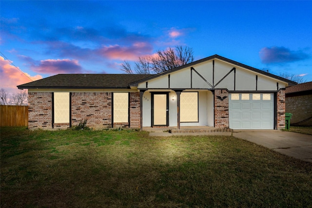 view of front of house with a garage and a lawn