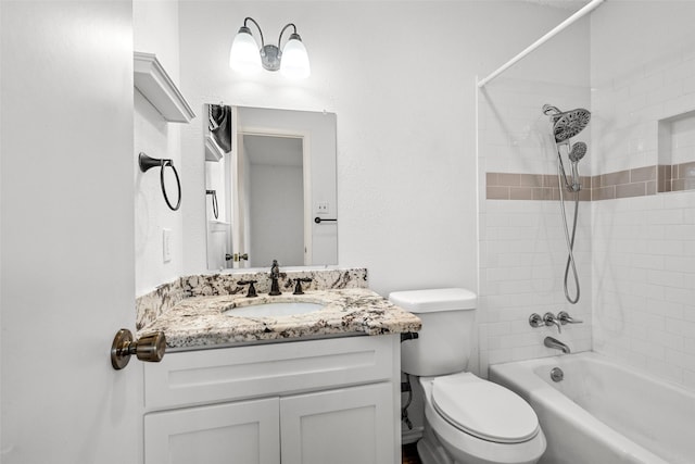 full bathroom featuring toilet, vanity, and tiled shower / bath combo