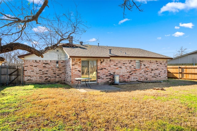 rear view of house featuring a patio area and a lawn