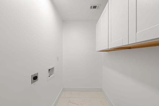 clothes washing area featuring cabinets, hookup for an electric dryer, and washer hookup