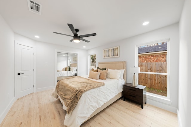 bedroom with a closet, ceiling fan, and light hardwood / wood-style floors