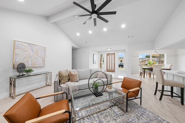 living room with ceiling fan, light hardwood / wood-style flooring, and lofted ceiling with beams