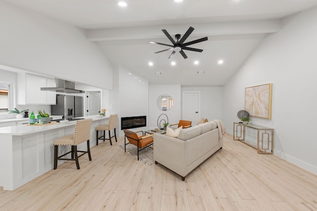 living room with high vaulted ceiling, beam ceiling, ceiling fan, and light hardwood / wood-style floors