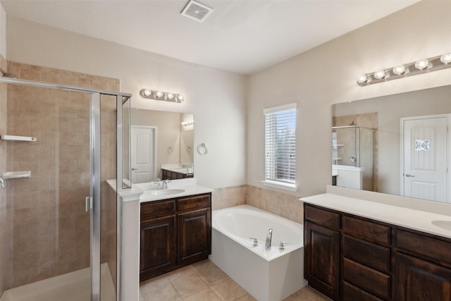 bathroom with shower with separate bathtub, tile patterned floors, and vanity