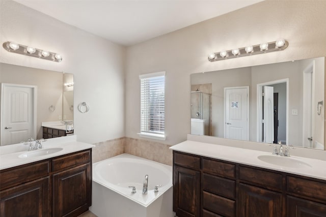 bathroom featuring shower with separate bathtub and vanity