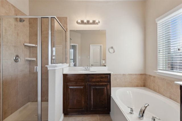 bathroom featuring plus walk in shower, tile patterned floors, and vanity