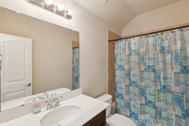 bathroom with lofted ceiling, vanity, and toilet