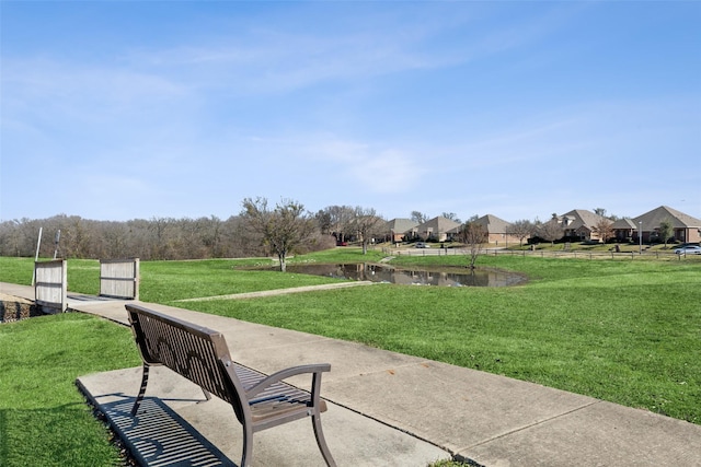 view of property's community featuring a yard and a water view