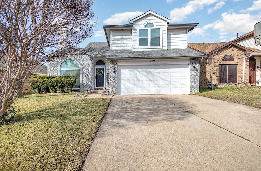 front of property with a front lawn and a garage