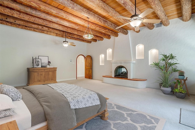 unfurnished living room featuring beamed ceiling, light colored carpet, wooden ceiling, and ceiling fan