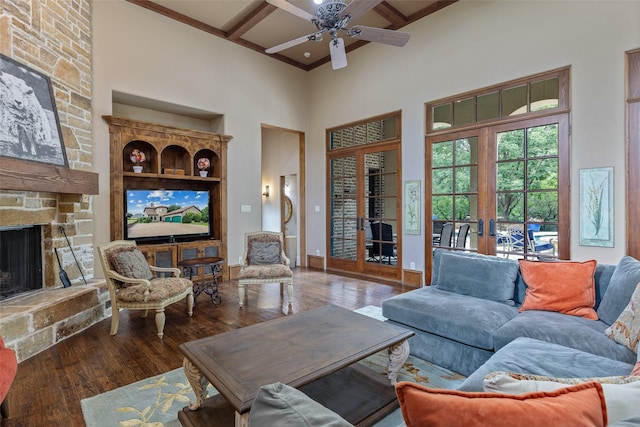 living room with coffered ceiling, french doors, beam ceiling, ceiling fan, and wood-type flooring