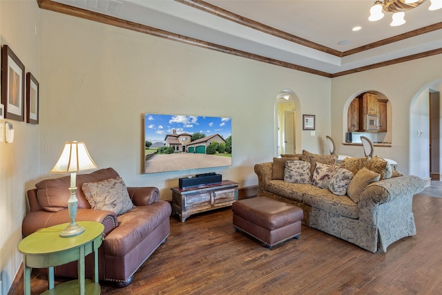 living room featuring dark hardwood / wood-style flooring, a chandelier, and ornamental molding