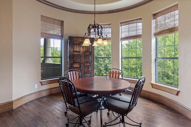 dining area with an inviting chandelier, crown molding, and hardwood / wood-style flooring