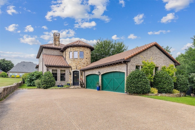 mediterranean / spanish home with a garage