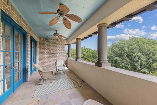 balcony with ceiling fan and french doors