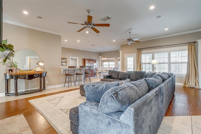 living room featuring ornamental molding, ceiling fan, and light hardwood / wood-style floors