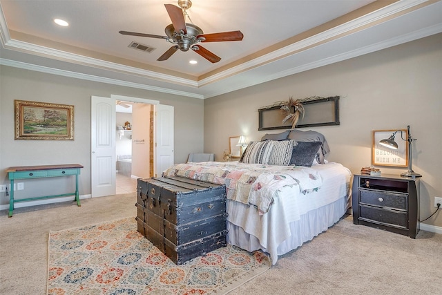 bedroom featuring a raised ceiling, light colored carpet, crown molding, ceiling fan, and ensuite bathroom