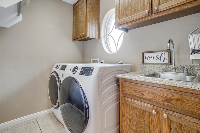 clothes washing area with cabinets, separate washer and dryer, light tile patterned floors, and sink