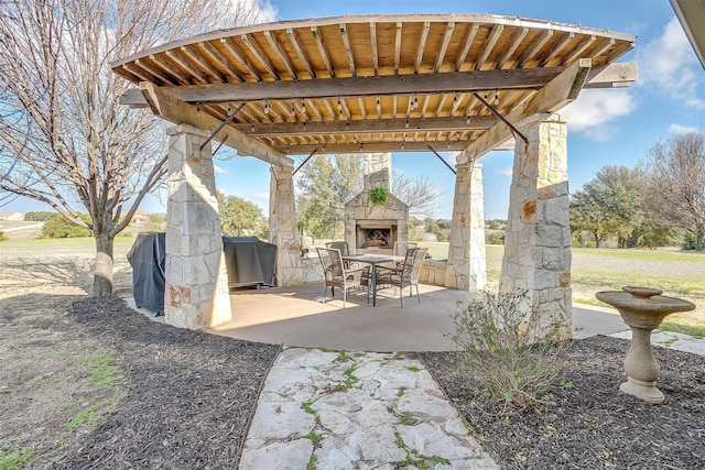 view of patio featuring an outdoor stone fireplace