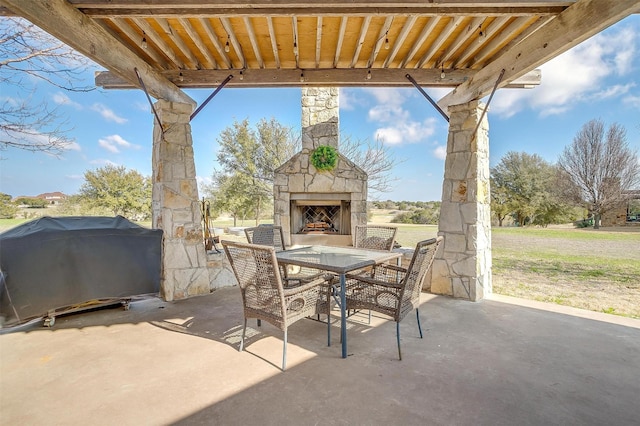 view of patio featuring grilling area and an outdoor stone fireplace