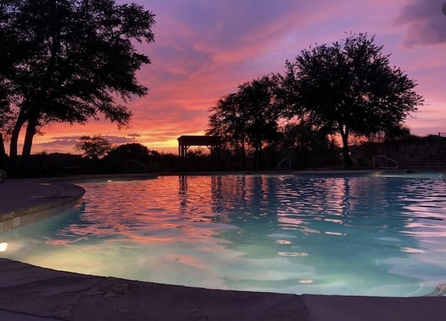 view of pool at dusk