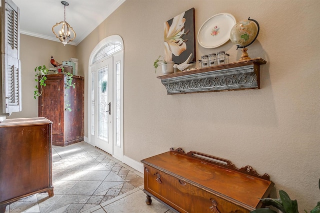 foyer featuring ornamental molding, light tile patterned floors, and a notable chandelier