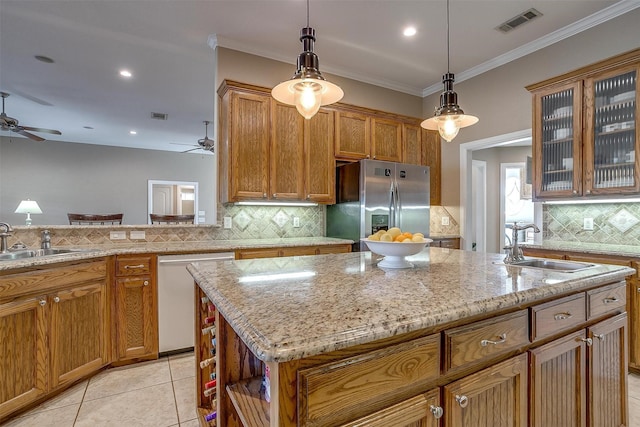 kitchen featuring white dishwasher, sink, a center island with sink, and stainless steel refrigerator with ice dispenser