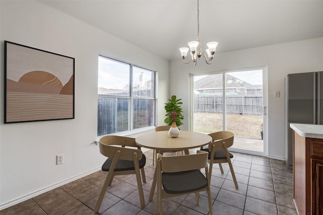 tiled dining area featuring a notable chandelier