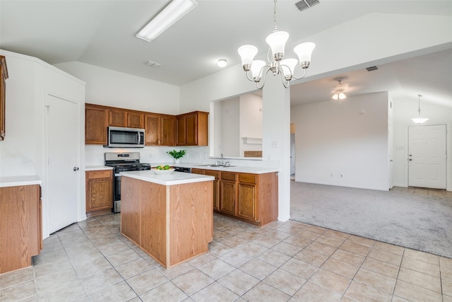 kitchen with a center island, stainless steel appliances, sink, hanging light fixtures, and a chandelier