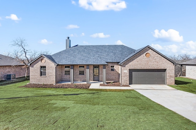 view of front of home with a garage, a front lawn, central air condition unit, and covered porch