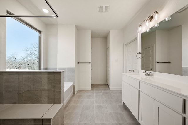 bathroom with vanity and a bathtub