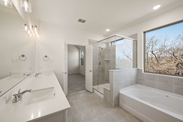 bathroom with vanity and separate shower and tub