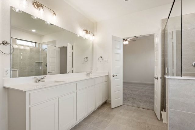 bathroom featuring vanity, a shower with shower door, and ceiling fan