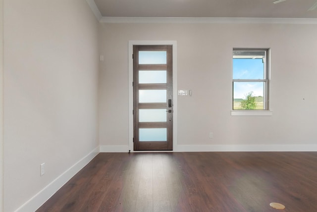 entrance foyer featuring dark wood-type flooring and crown molding