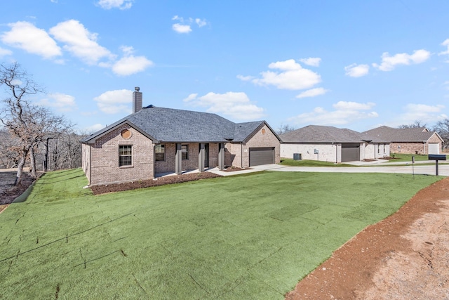 view of front of house featuring a garage and a front lawn