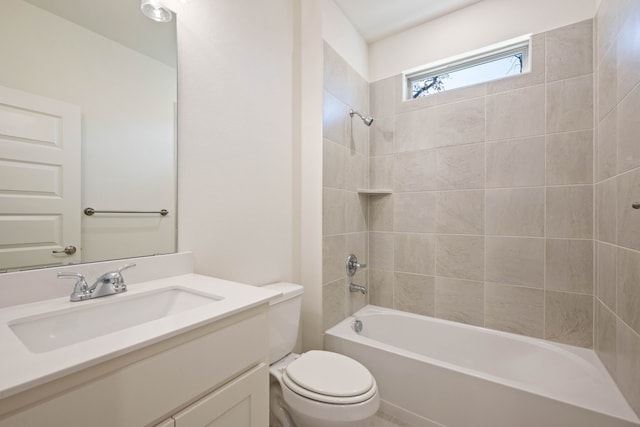 full bathroom featuring tiled shower / bath combo, vanity, and toilet