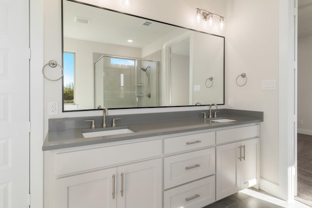 bathroom featuring vanity, tile patterned floors, and a shower with shower door